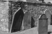 Gekippter Grabstein im Friedhof der Sweetheart Abbey